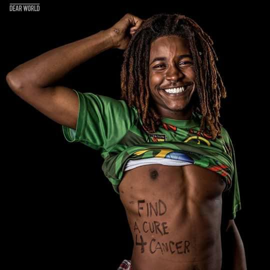 Qevonte with "Find A Cure 4 Cancer" written on his stomach for a Dear World portrait
