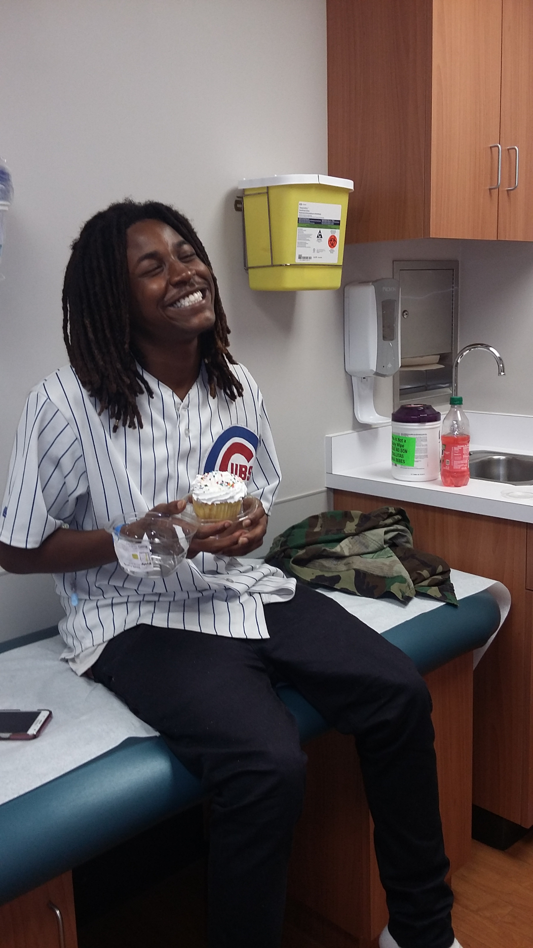 Qevonte laughing with a cupcake at a clinic appointment
