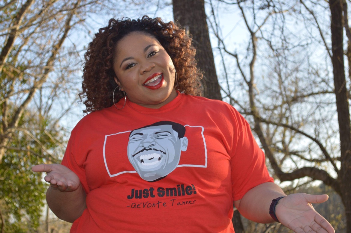 Founder Rosemary Sherrod smiling warmly while wearing a Just Smile tribute t-shirt honoring her son Qevonte.
